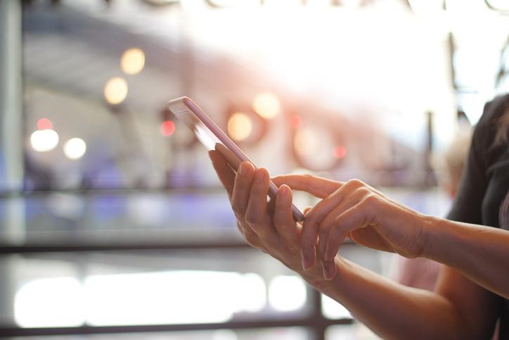 Woman texting in windowed space 